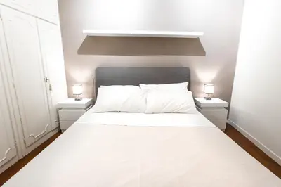 a bedroom with a white bed with two night stands at Accogliente casa a due passi da Piazza Navona in Rome