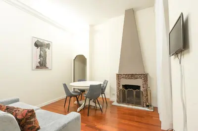 a living room with a table and a fireplace at Accogliente casa a due passi da Piazza Navona in Rome