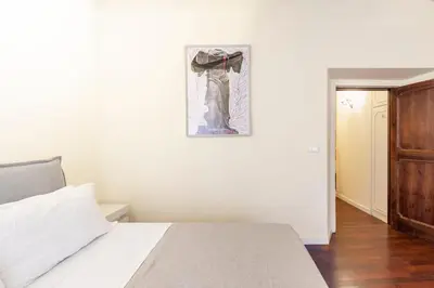 a bedroom with a bed and a picture on the wall at Accogliente casa a due passi da Piazza Navona in Rome