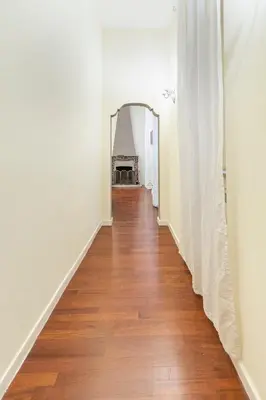 a hallway with white walls and a wooden floor at Accogliente casa a due passi da Piazza Navona in Rome