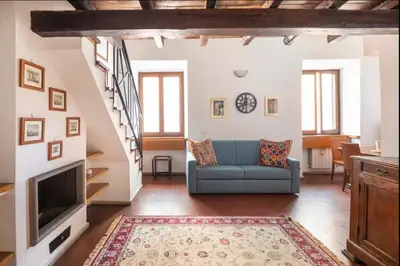 a living room with a blue couch and a fireplace at Accogliente casa al Pantheon in Rome