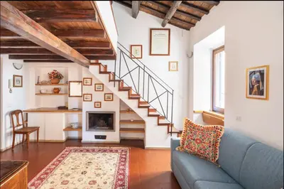 a living room with a blue couch and a staircase at Accogliente casa al Pantheon in Rome