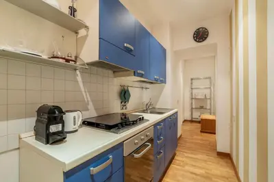 a kitchen with blue cabinets and a stove top oven at GuestHost - Suite dell'Emporio in Rome