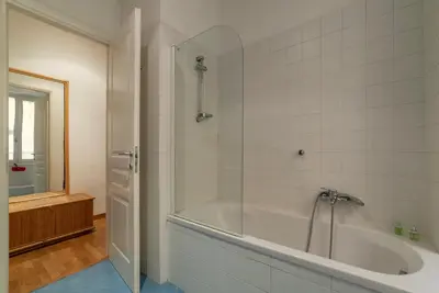 a bathroom with a tub and a glass shower at GuestHost - Suite dell'Emporio in Rome
