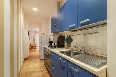 a kitchen with blue cabinets and a sink at GuestHost - Suite dell'Emporio in Rome