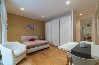 a bedroom with a bed and a table and a chair at GuestHost - Suite dell'Emporio in Rome