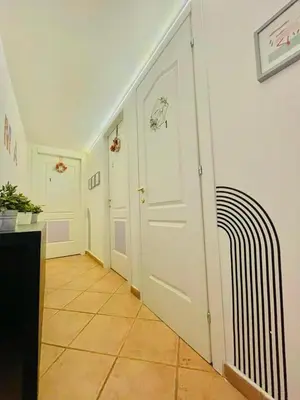 a hallway with a white door in a room at La Cornice Apartment in Rome