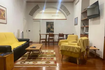 a living room with a couch and chairs and a table at Loft Accogliente - Piazza San Giovanni in Rome