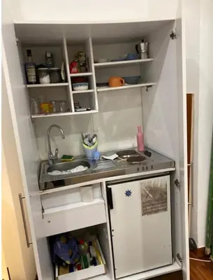 a small kitchen with a sink and a refrigerator at Loft Accogliente - Piazza San Giovanni in Rome