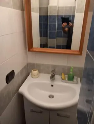 a person taking a picture of a bathroom sink at Loft Accogliente - Piazza San Giovanni in Rome