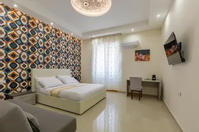 a bedroom with a bed and a table with a chair at Hyper Lodge Termini GuestHouse in Rome