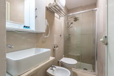a bathroom with a sink and a toilet and a shower at Hyper Lodge Termini GuestHouse in Rome