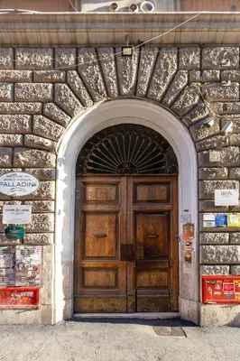 a large wooden door in a stone building at Hyper Lodge Termini GuestHouse in Rome