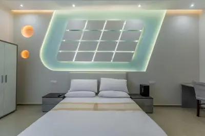 a bedroom with a large bed and a large skylight at Hyper Lodge Termini GuestHouse in Rome