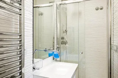 a bathroom with a sink and a glass shower at [ROMAN JEWEL] Elegant apartment near the center in Rome