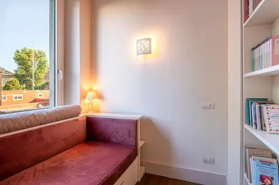 a room with a bench in front of a window at [ROMAN JEWEL] Elegant apartment near the center in Rome