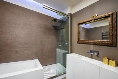 a bathroom with a shower and a sink and a mirror at [ROMAN JEWEL] Elegant apartment near the center in Rome