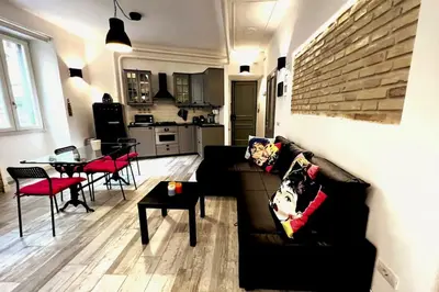 a living room with a black couch and a table at Modern Apartment near the Vatican in Rome