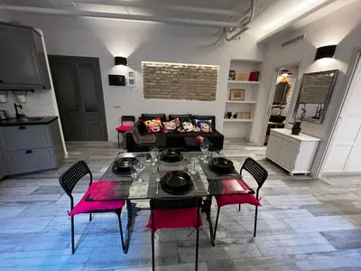 a living room with a table and a couch at Modern Apartment near the Vatican in Rome