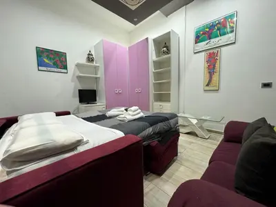 a room with two beds and a couch in it at Ponte Milvio Lovely Studio in Rome