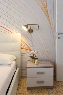 a bedroom with a bed and a table with a lamp at Elide - Nido d'amore in Ponte Milvio con Balcone in Rome