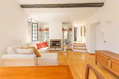 a living room with a white couch and a fireplace at Piede Charming Apartment in Rome