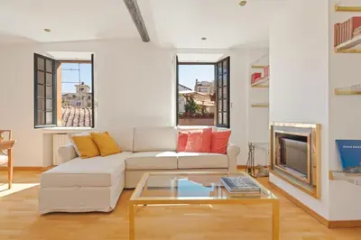 a living room with a white couch and a coffee table at Piede Charming Apartment in Rome