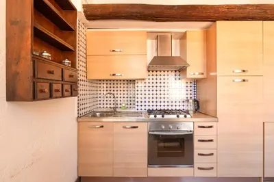 a kitchen with a stove and a sink at Piede Charming Apartment in Rome