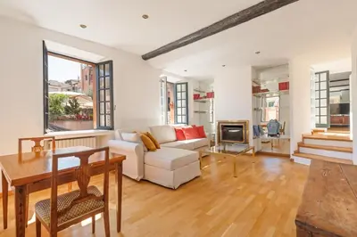 a living room with a white couch and a table at Piede Charming Apartment in Rome