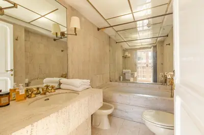 a bathroom with a tub and a toilet and a sink at Piede Charming Apartment in Rome
