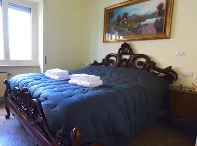 a bedroom with a blue bed with towels on it at stazione trastevere\u516c\u5bd3 in Rome