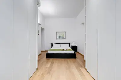 a bedroom with a bed and a wooden floor at Incantevole appartamento in pieno centro a Roma in Rome