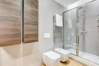 a white bathroom with a toilet and a shower at Incantevole appartamento in pieno centro a Roma in Rome
