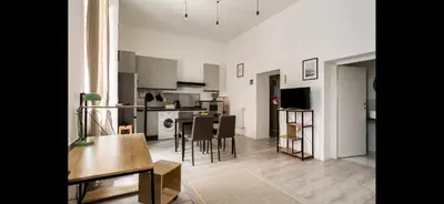 a living room and kitchen with a table and chairs at Leonidas’s House in Rome