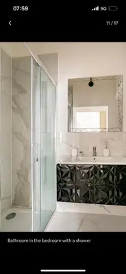 a bathroom with a shower with a sink and a mirror at Leonidas’s House in Rome