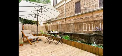 a patio with an umbrella and a table and chairs at Leonidas’s House in Rome