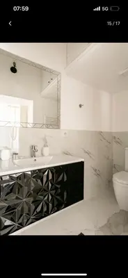 a white bathroom with a sink and a toilet at Leonidas’s House in Rome
