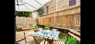 a small table with an umbrella on a patio at Leonidas’s House in Rome