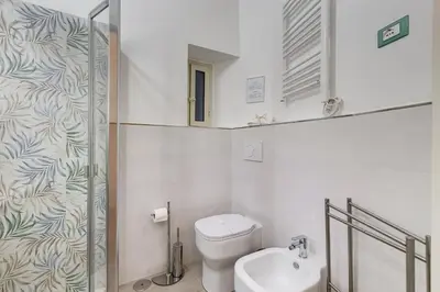 a small bathroom with a toilet and a sink at MONTI44 Boutique Apartment in Rome