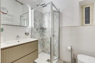 a bathroom with a shower and a sink at MONTI44 Boutique Apartment in Rome