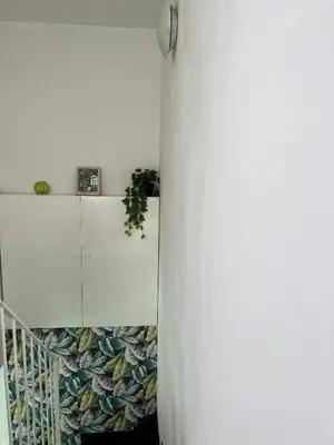 a room with a white wall and a white cabinet at Loft Panoramico San Giovanni in Rome