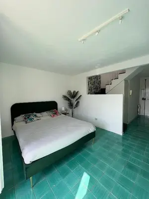 a bedroom with a bed and a staircase at Loft Panoramico San Giovanni in Rome