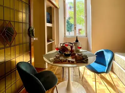 a table in a kitchen with chairs and a table with food on it at Z-ArchSuites Urbs in Rome
