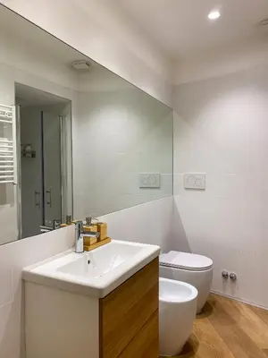 a bathroom with a sink and a toilet and a mirror at Boho Suites - Rome Colosseum in Rome