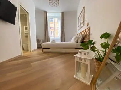 a white living room with a couch and a window at Boho Suites - Rome Colosseum in Rome