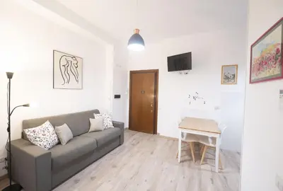 a living room with a couch and a table at Lovely Apartment in Hip and Vibrant Pigneto in Rome