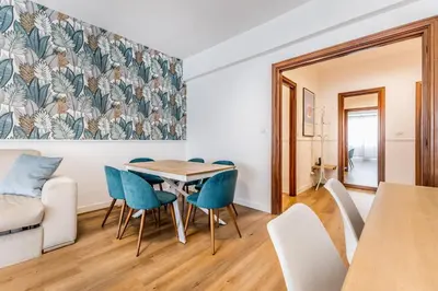 a living room with a table and chairs and a couch at Real Vatican Inn in Rome