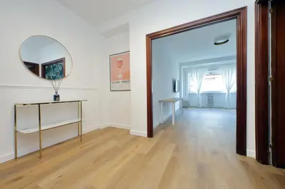 an empty room with a mirror and a table at Real Vatican Inn in Rome