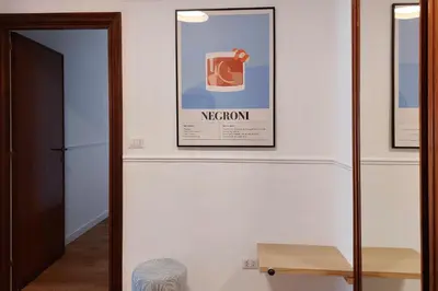 a hallway with a picture of a mug on the wall at Real Vatican Inn in Rome