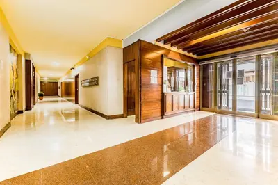 an empty hallway of a building with glass doors at Real Vatican Inn in Rome